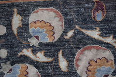 A close-up of a handmade Afghan Chobi rug featuring intricate floral patterns in earthy tones.