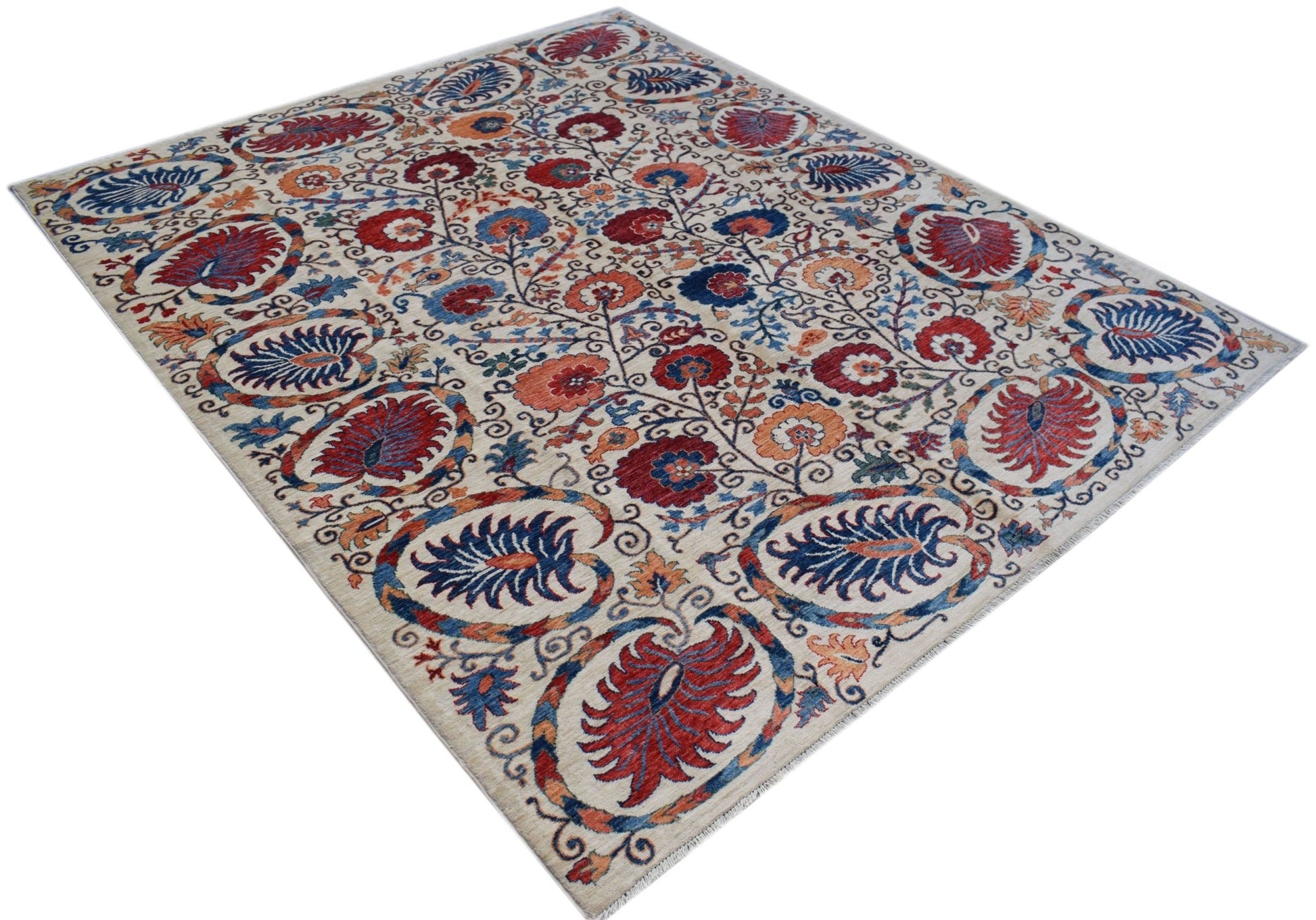 An Afghan Chobi rug featuring a traditional Suzani floral pattern in red, blue, and orange tones.