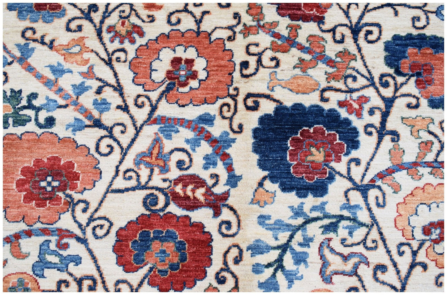 Handwoven Afghan Chobi rug featuring a traditional floral Suzani pattern in red, blue, and cream.