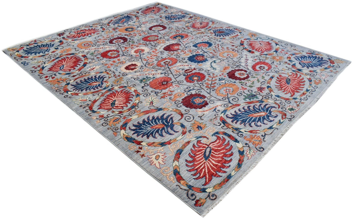 An Afghan Chobi rug featuring a traditional Suzani floral pattern in red, blue, and orange tones.