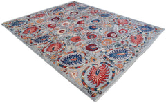 An Afghan Chobi rug featuring a traditional Suzani floral pattern in red, blue, and orange tones.