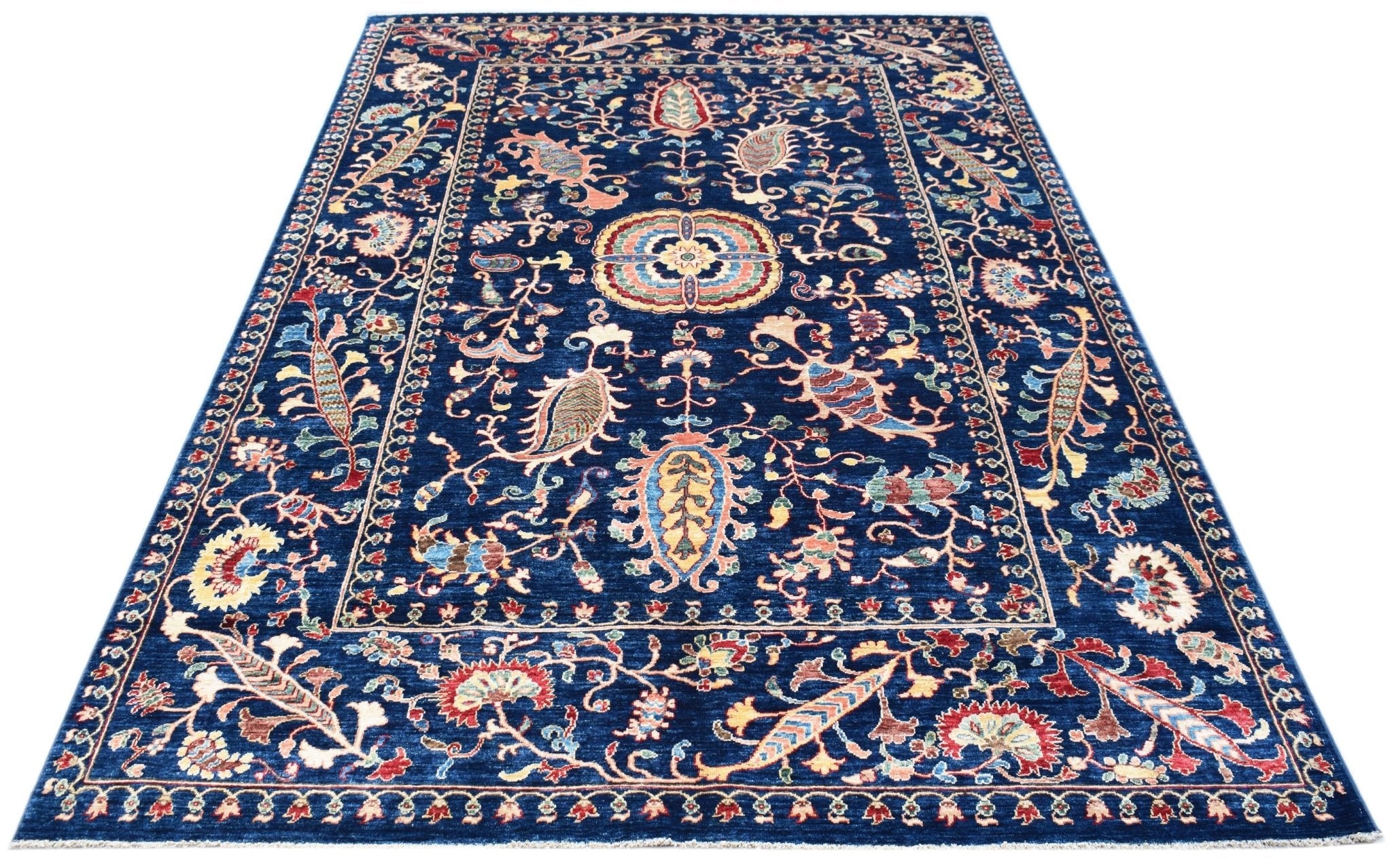 A rectangular Afghan Chobi rug featuring a traditional floral Suzani pattern on a deep blue field.