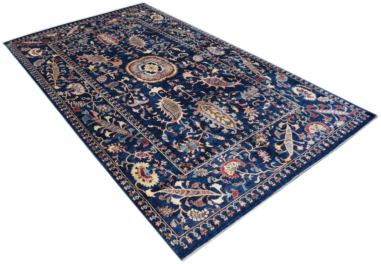 A rectangular Afghan Chobi rug featuring a traditional floral pattern in shades of blue and red.