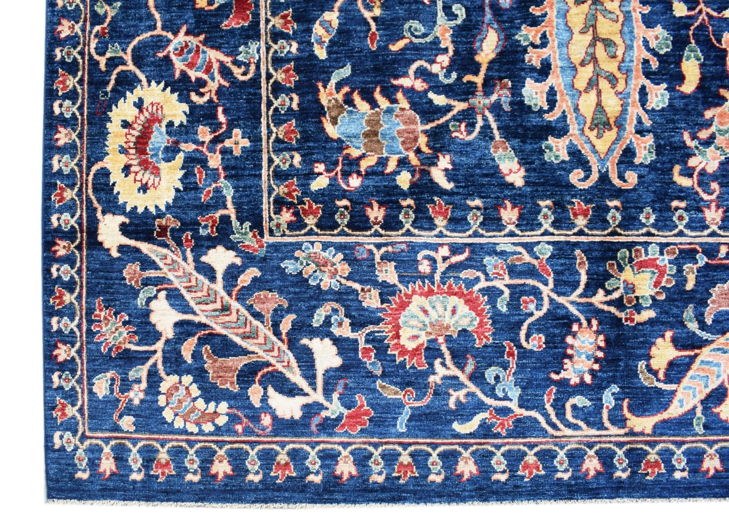 A handmade Afghan Chobi rug featuring intricate floral patterns in shades of blue and red.