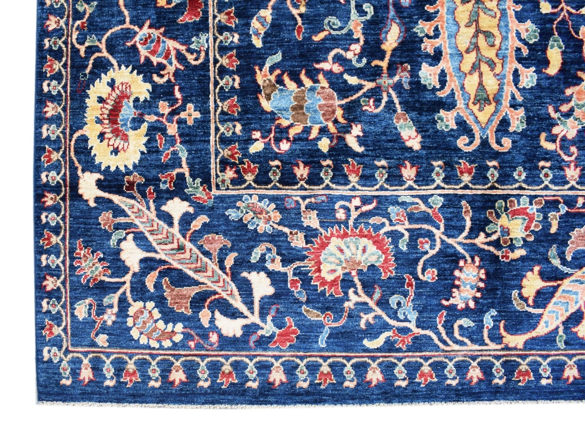 A handmade Afghan Chobi rug featuring intricate floral patterns in shades of blue and red.