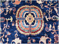 A handmade Afghan Chobi rug featuring a central floral medallion on a deep blue background.