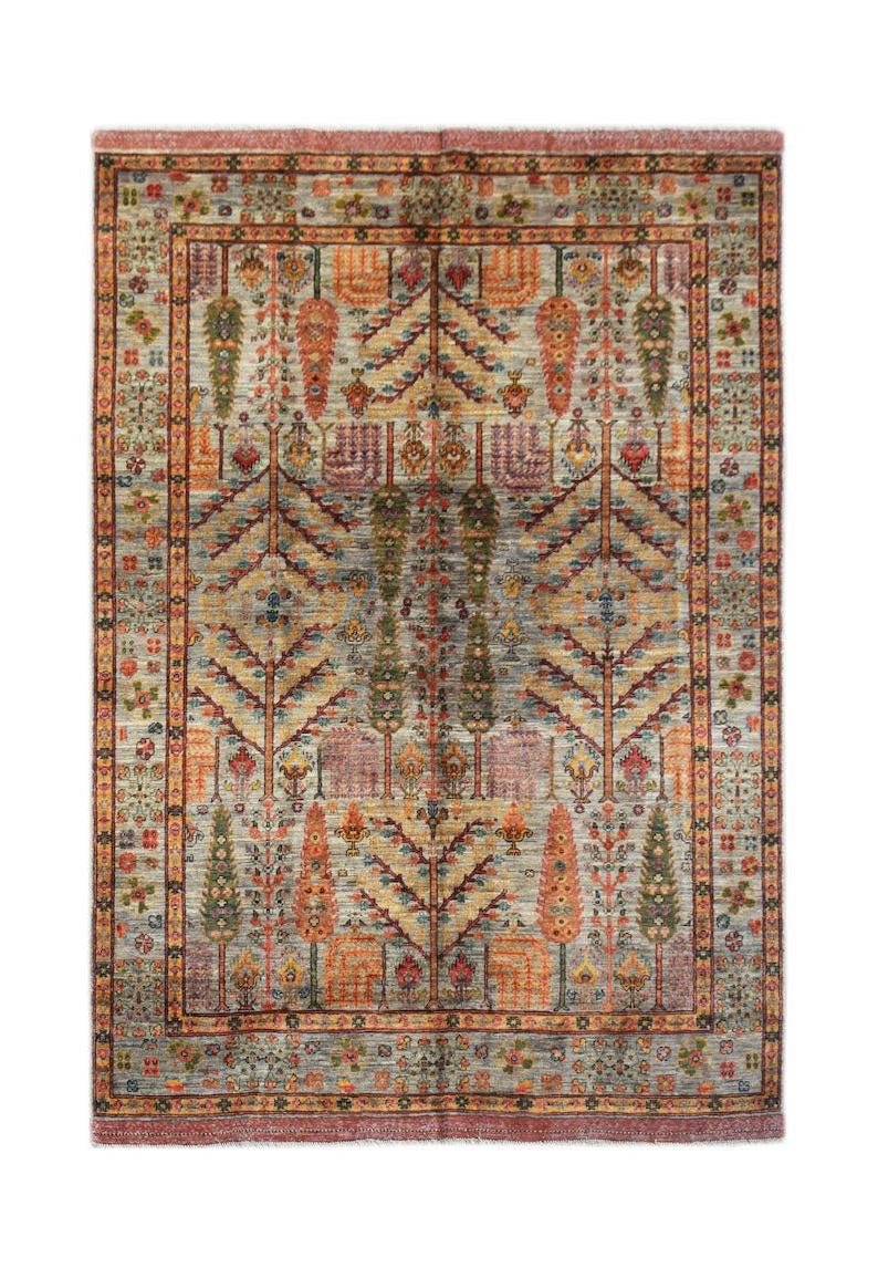 A handmade Afghan Chobi rug featuring a traditional Tree of Life pattern in earthy tones.