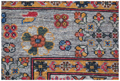 A close-up of an Afghan Chobi rug featuring intricate floral patterns in earthy tones.