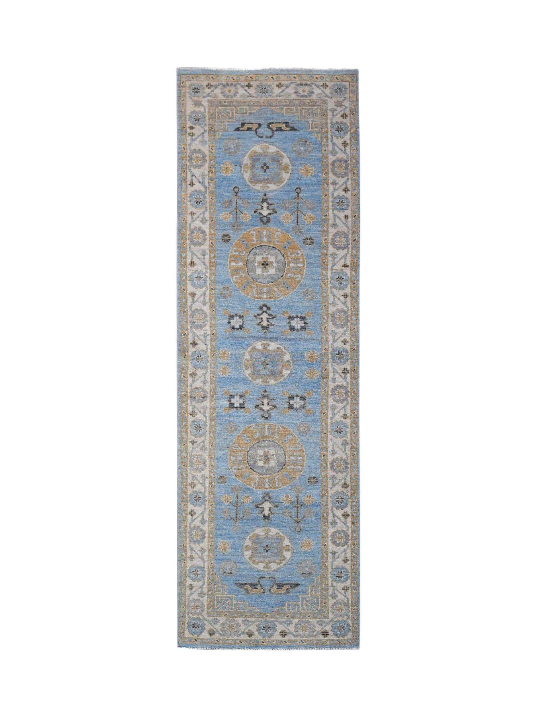 A handwoven Afghan Chobi runner rug featuring traditional circular motifs in blue and tan tones.