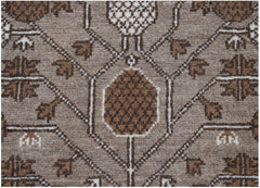 A close-up of an Afghan Chobi runner featuring a geometric pattern in shades of brown and cream.