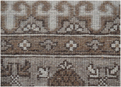 A close-up of a handmade Afghan Chobi runner featuring intricate geometric patterns in natural wool.