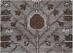 A handmade Afghan Chobi runner featuring a geometric brown and grey floral pattern.