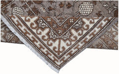A handmade Afghan Chobi runner with a brown and cream geometric Khotan pattern and fringe.