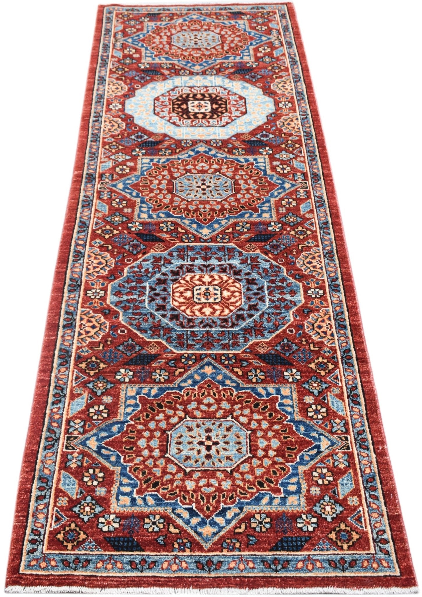 A handmade Afghan Chobi runner featuring a traditional Mamluk medallion pattern in red and blue.