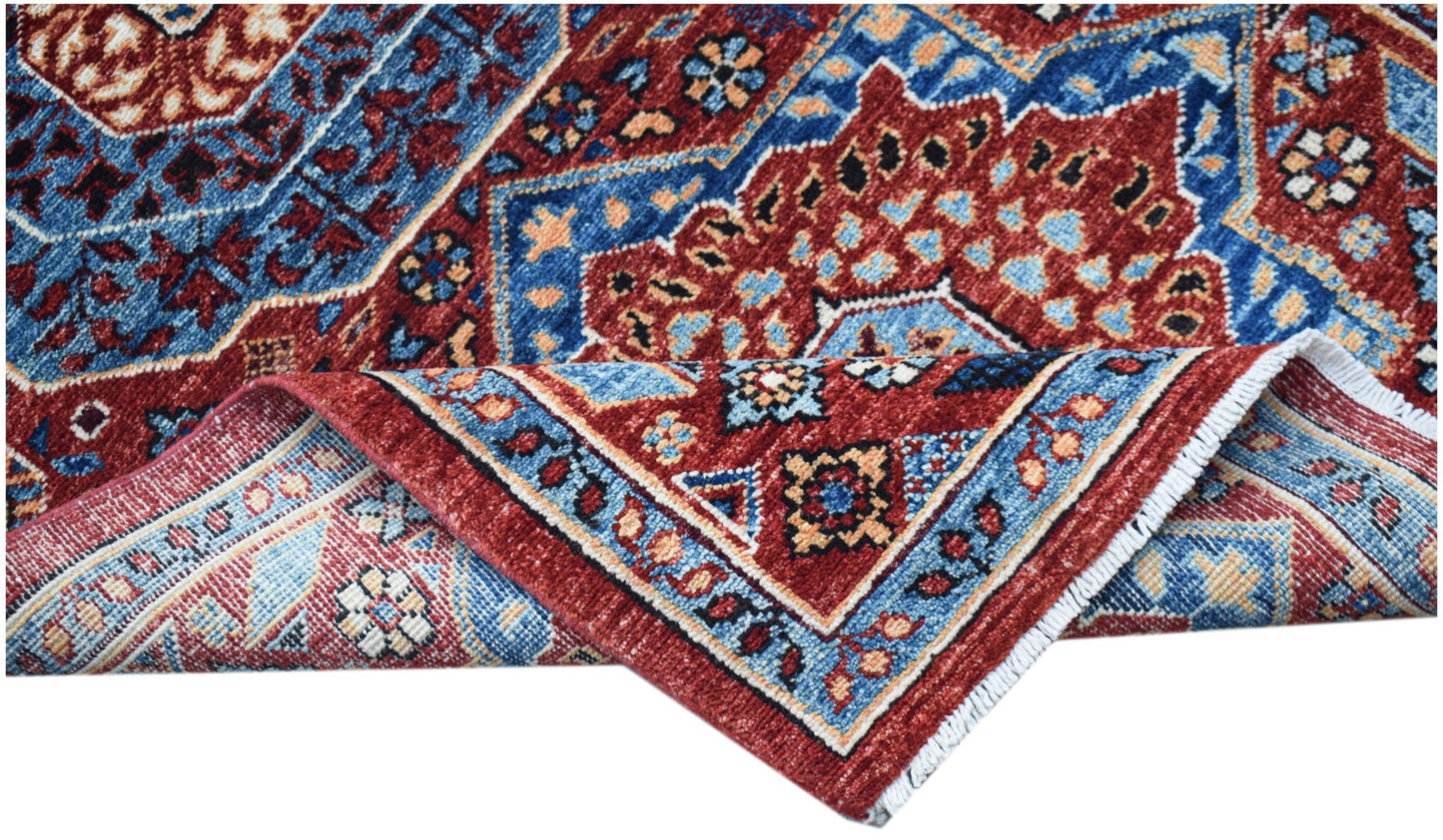 A handmade Afghan Chobi runner featuring a traditional red and blue Mamluk medallion pattern.