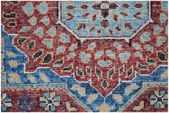 A close-up of a handwoven Afghan Chobi runner featuring a detailed red and blue Mamluk pattern.