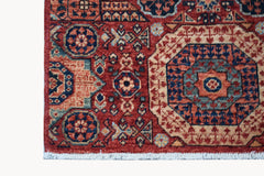 A handmade Afghan Chobi runner featuring a traditional red Mamluk medallion pattern.