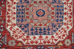 A close-up of a handwoven Afghan Chobi runner featuring a detailed Mamluk medallion pattern.