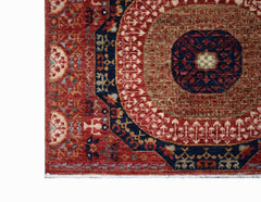 A handmade Afghan Chobi runner featuring a traditional red and blue Mamluk medallion pattern.