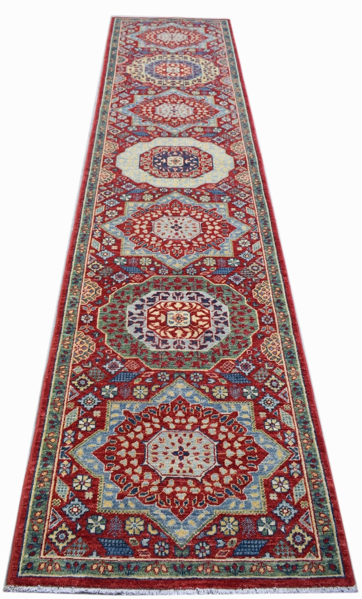A handmade Afghan Chobi runner featuring a traditional Mamluk medallion pattern in red and blue.