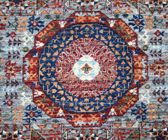 A handmade Afghan Chobi runner featuring a detailed Mamluk medallion in red and blue tones.