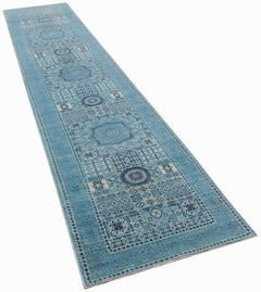 A long, handmade Afghan Chobi runner rug featuring intricate blue Mamluk geometric patterns.