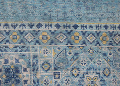 A close-up of a handmade Afghan Mamluk runner featuring intricate blue and yellow geometric motifs.