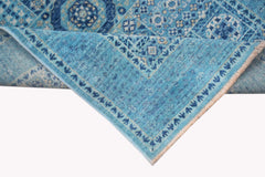 A blue Afghan Chobi runner rug with a Mamluk medallion pattern and a fringed edge.