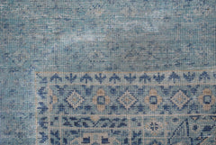 A close-up of a handmade Afghan Chobi runner featuring a blue and beige geometric Mamluk pattern.