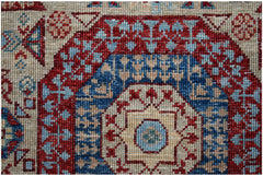 A close-up of an Afghan Chobi runner featuring a traditional Mamluk medallion in red and blue.