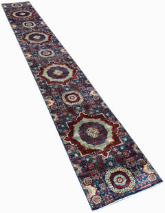 A long, handmade Afghan Chobi runner rug featuring intricate Mamluk-style medallions in blue and red.