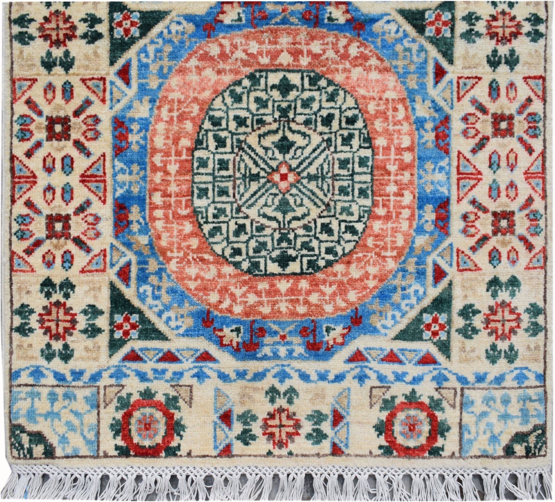 A handmade Afghan Chobi runner featuring a central geometric medallion in red, blue, and green.