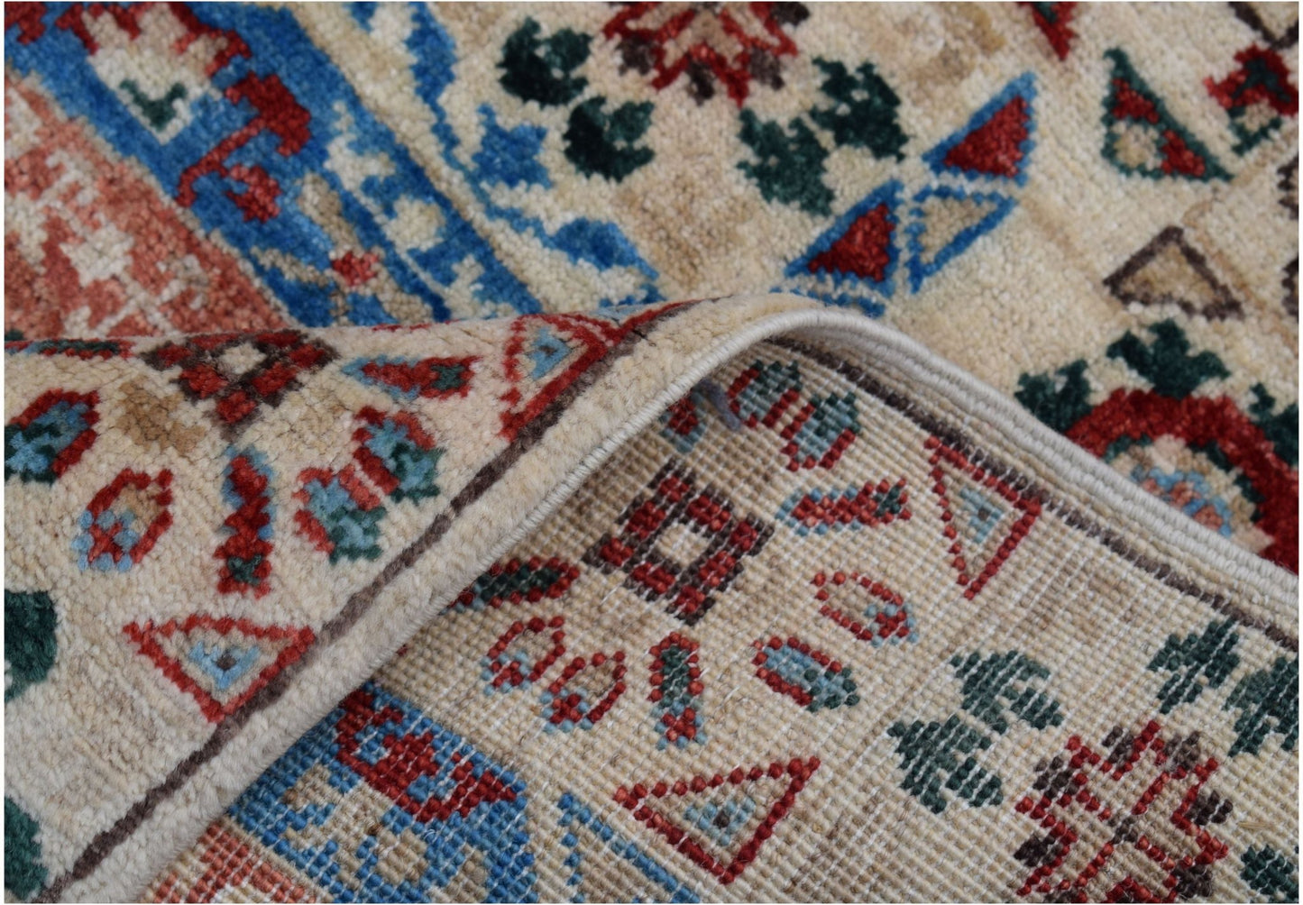 A close-up of a handmade Afghan Chobi runner featuring a traditional Mamluk medallion pattern.