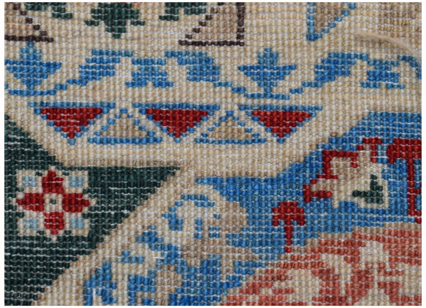 A close-up view of a handmade Afghan Chobi runner featuring intricate geometric Mamluk patterns.