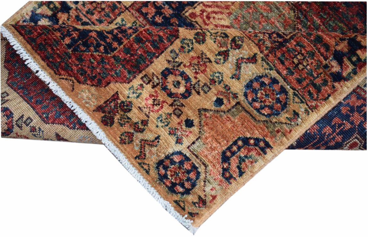 A handmade Afghan Chobi runner featuring a traditional Mamluk medallion pattern in warm tones.