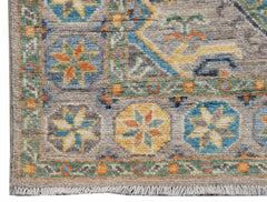 A handwoven Afghan Chobi runner featuring traditional geometric floral patterns in earthy tones.