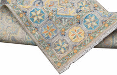An Afghan Chobi runner with a traditional geometric pattern in blue, yellow, and orange tones.