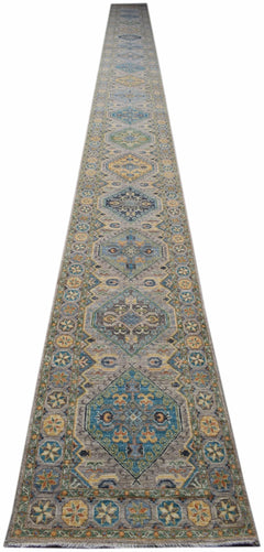 A long, handwoven Afghan Chobi runner rug featuring geometric diamond patterns in earthy tones.