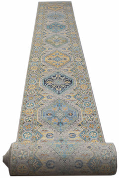 A handmade Afghan Chobi runner rug featuring a repeating geometric pattern in blue and yellow.