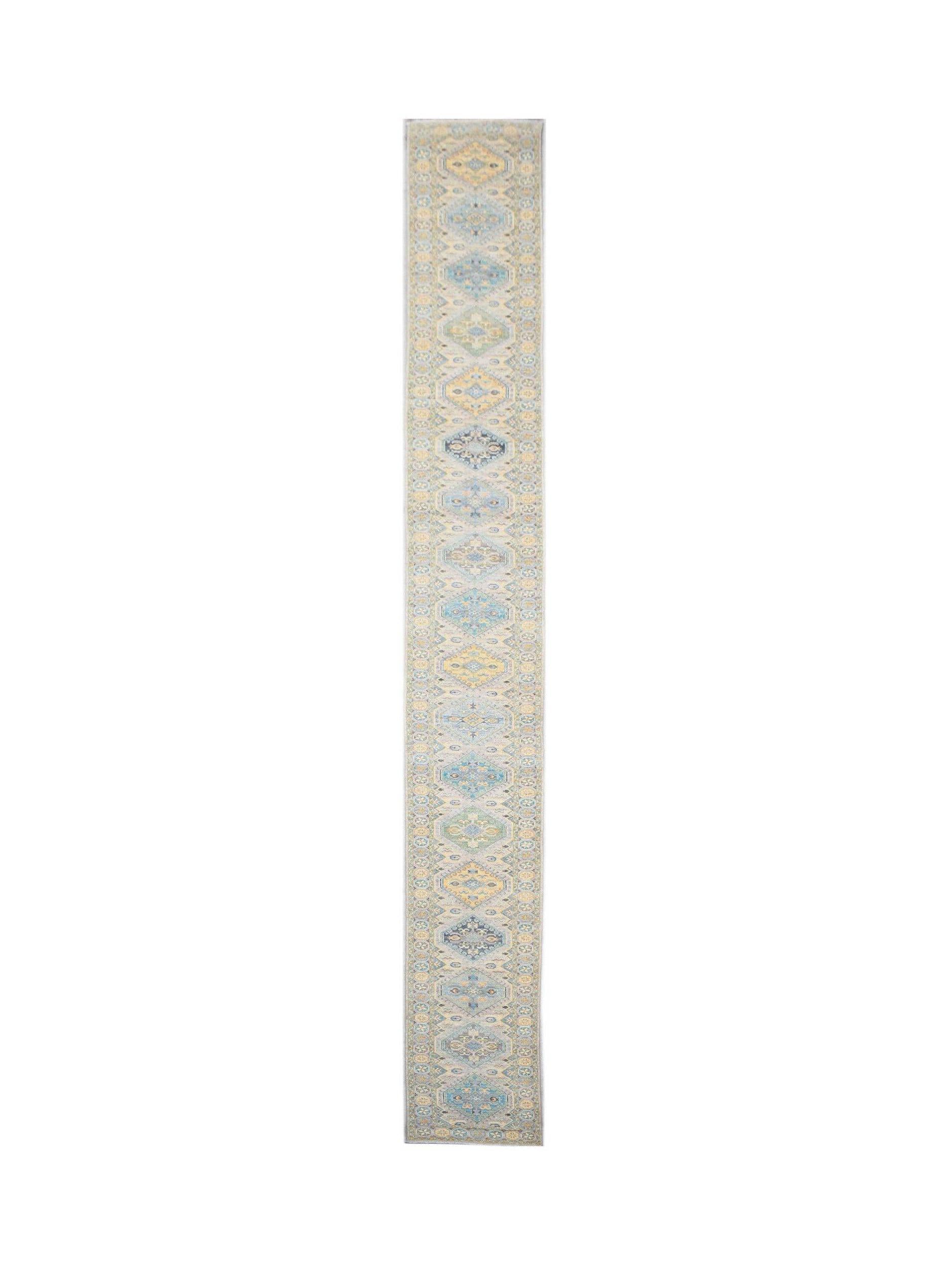 A long, handwoven Afghan Chobi runner rug featuring a repeating diamond pattern in soft blue and gold.