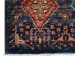 A close-up of an Afghan Chobi runner featuring a traditional blue, red, and cream floral pattern.
