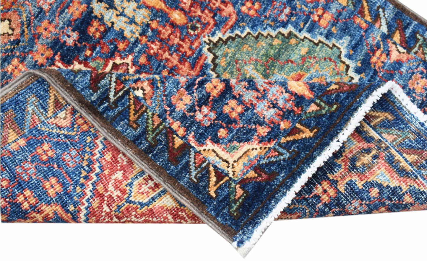 A folded Afghan Chobi runner featuring a traditional intricate pattern in blue, red, and gold.