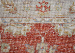 A close-up of a handwoven Afghan Chobi runner featuring traditional floral patterns in earthy tones.