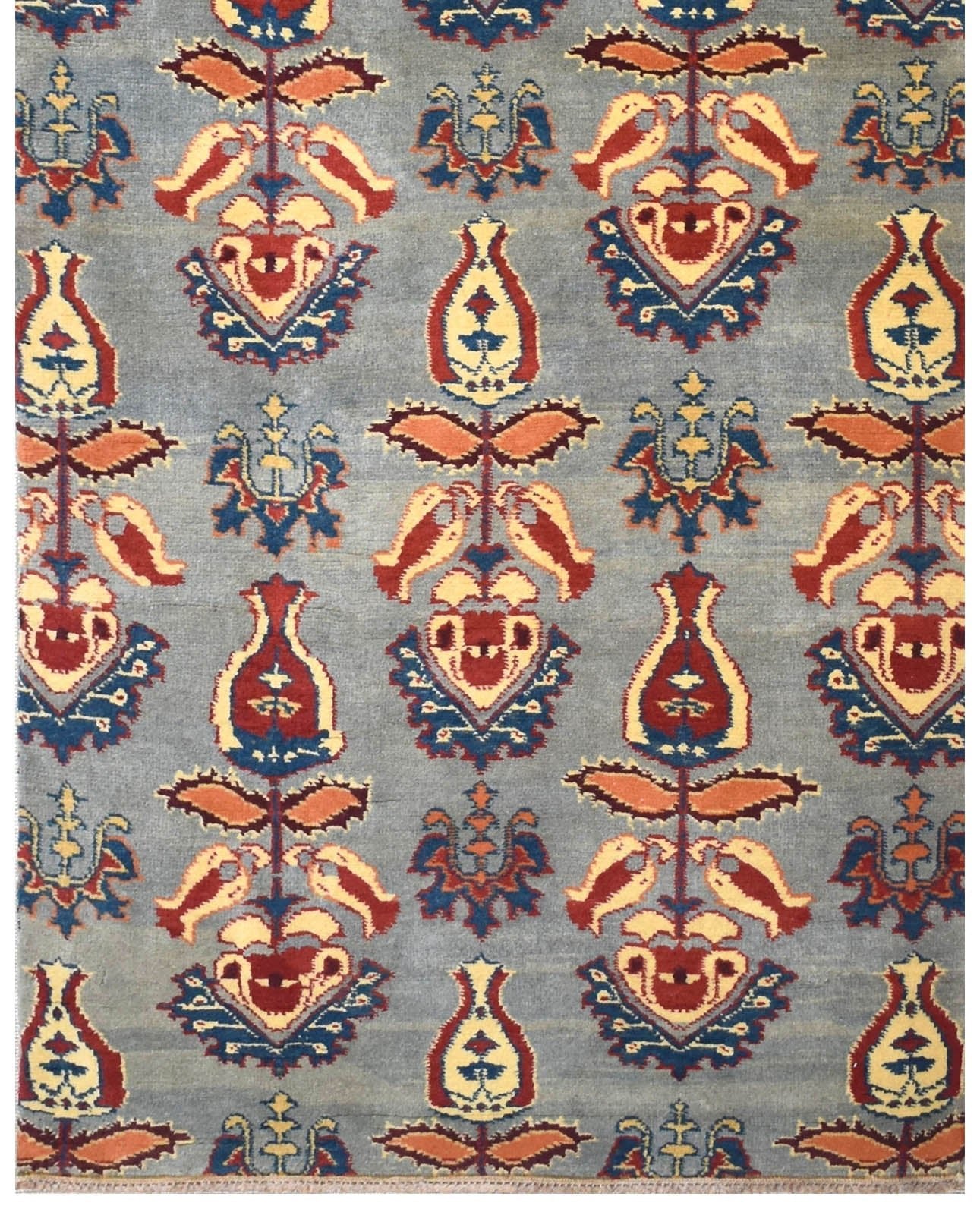 Handmade Afghan Chobi runner featuring a repeating floral motif in red, yellow, and blue on grey.