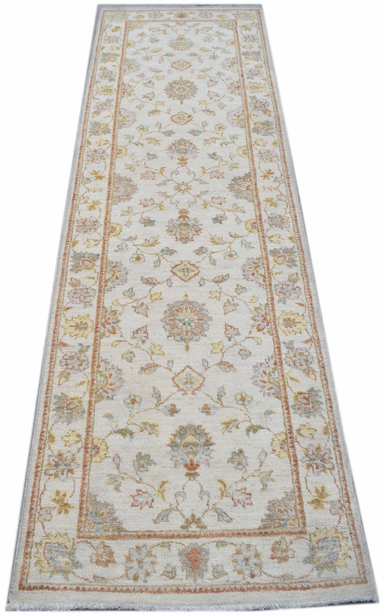 A handmade Afghan Chobi runner rug featuring a traditional floral pattern in soft earthy tones.