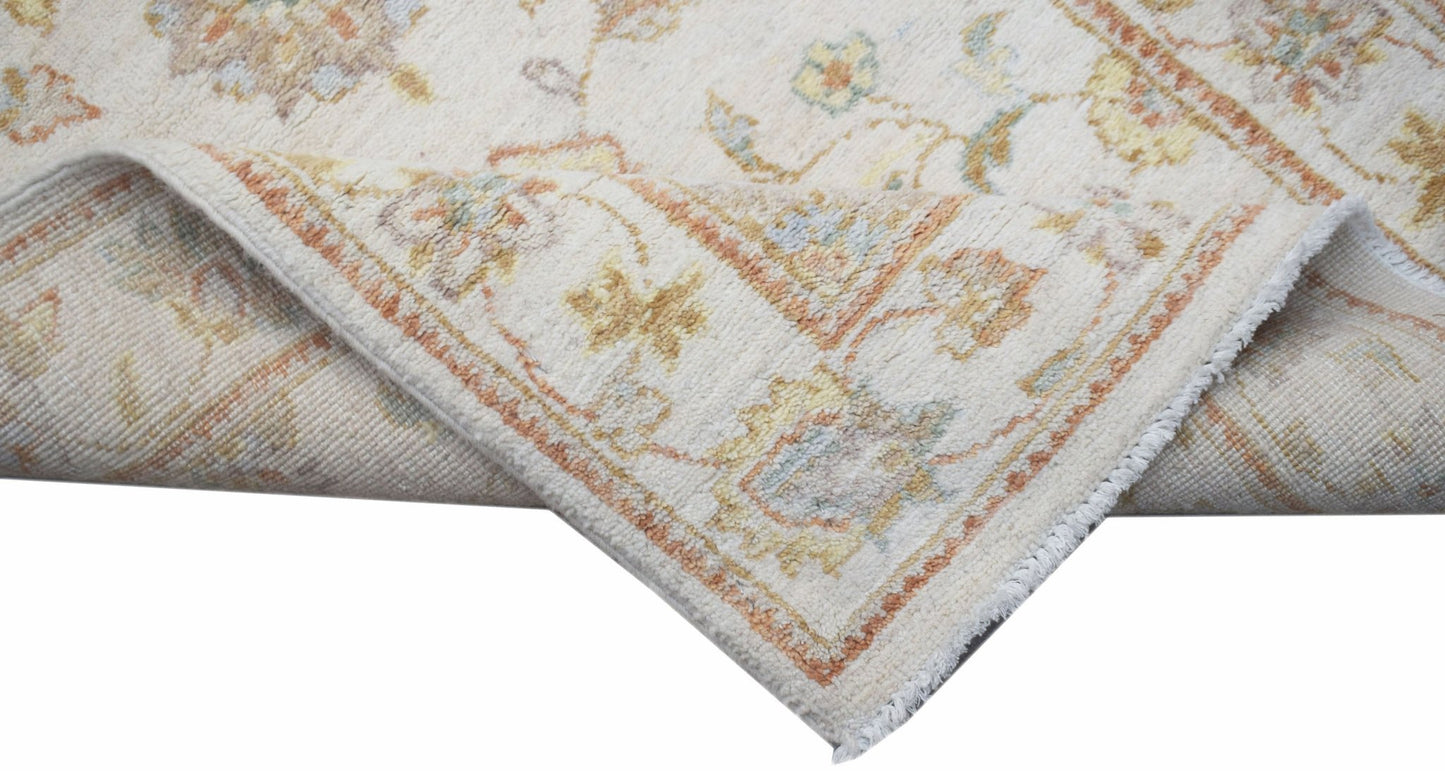 A handmade Afghan Chobi runner featuring a traditional floral pattern in soft, earthy tones.