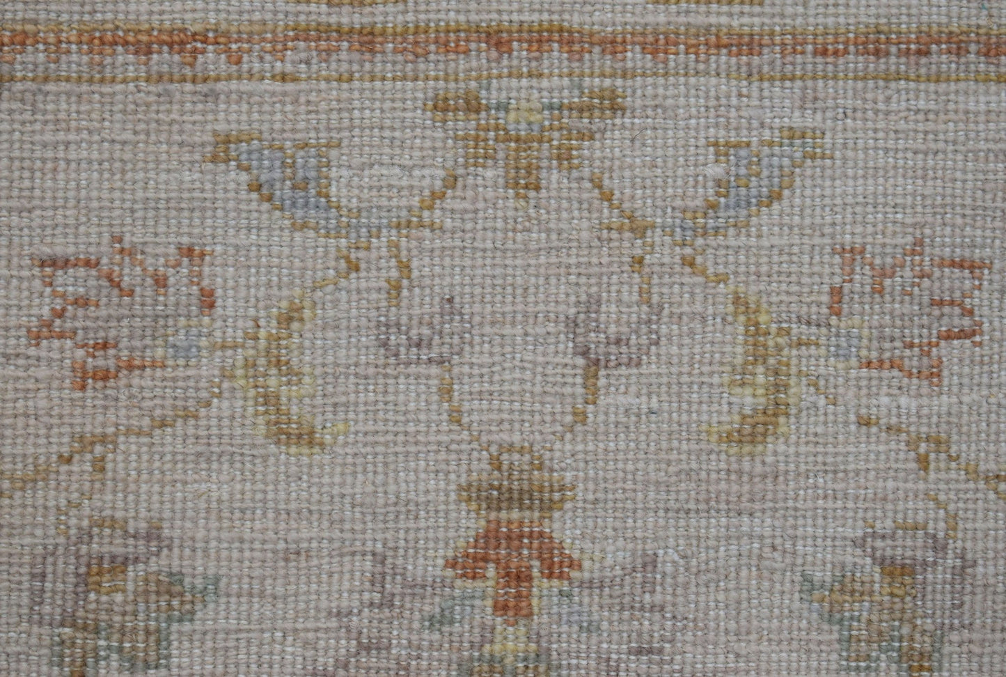 A close-up of an Afghan Chobi runner featuring a traditional floral pattern in soft earth tones.
