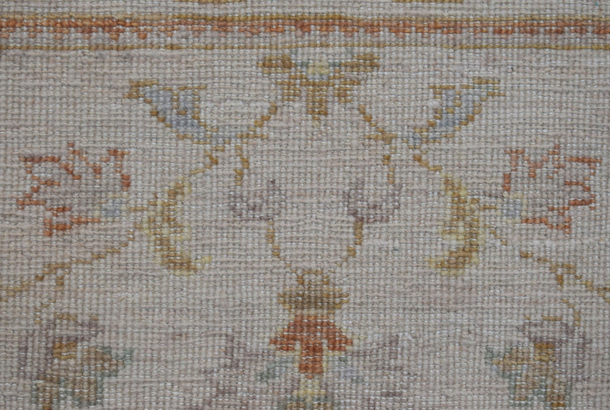 A close-up of an Afghan Chobi runner featuring a traditional floral pattern in soft earth tones.