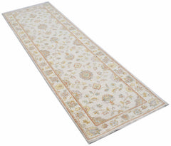 An Afghan Chobi runner rug featuring a traditional floral pattern in soft, muted earth tones.