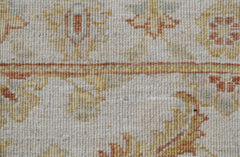 A close-up of an Afghan Chobi runner featuring traditional floral patterns in earthy wood tones.